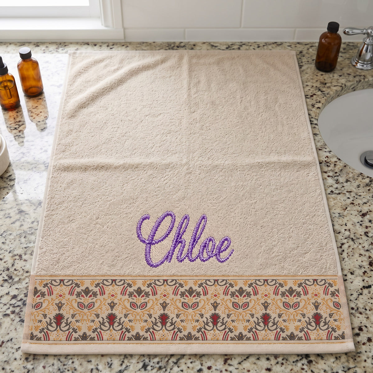 Chloe personalized hair towel, purple script embroidery on cream cotton with a patterned border — photo 2