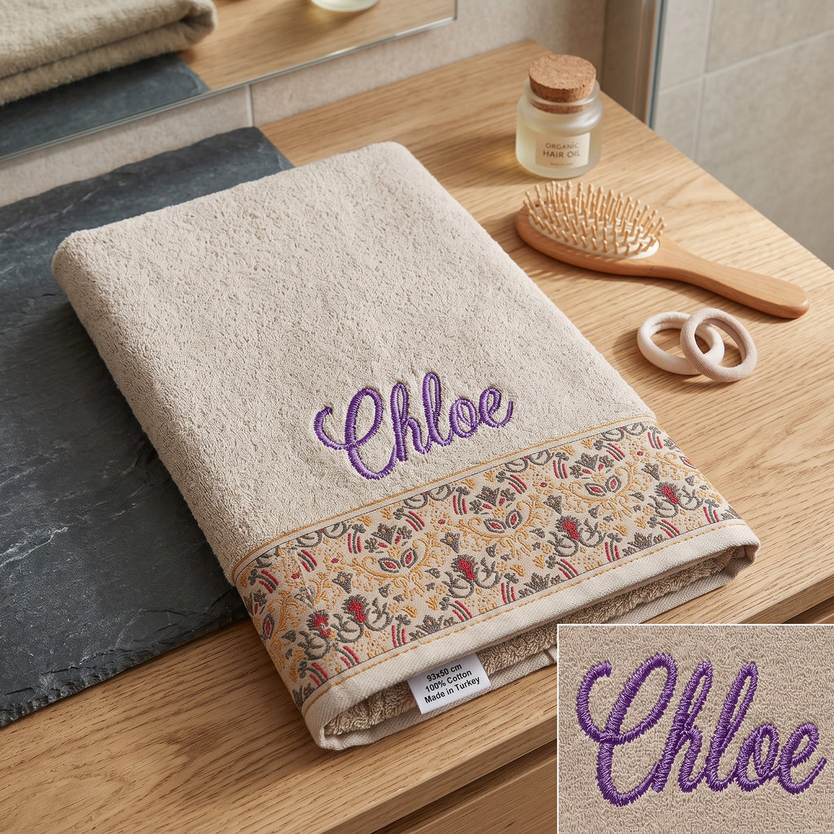 Chloe personalized hair towel, purple script embroidery on cream cotton with a patterned border — photo 4