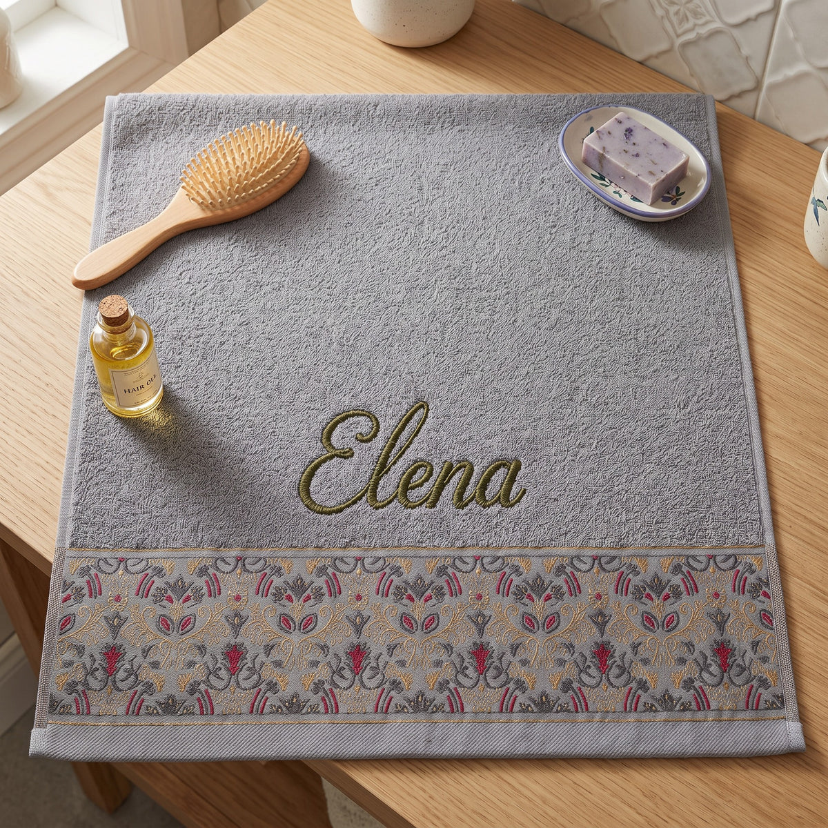 Elena personalized hair towel, olive green script embroidery on light gray cotton with a patterned border — photo 2