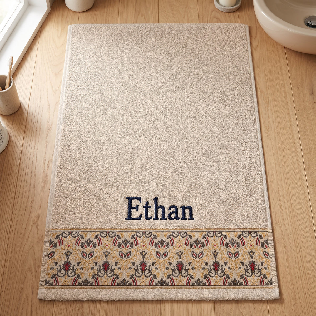 Ethan personalized hair towel, navy serif embroidery on cream cotton with a patterned border — photo 7