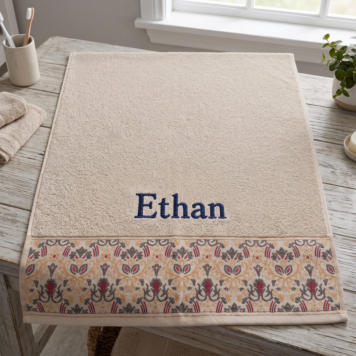 Ethan personalized hair towel, navy serif embroidery on cream cotton with a patterned border — photo 9