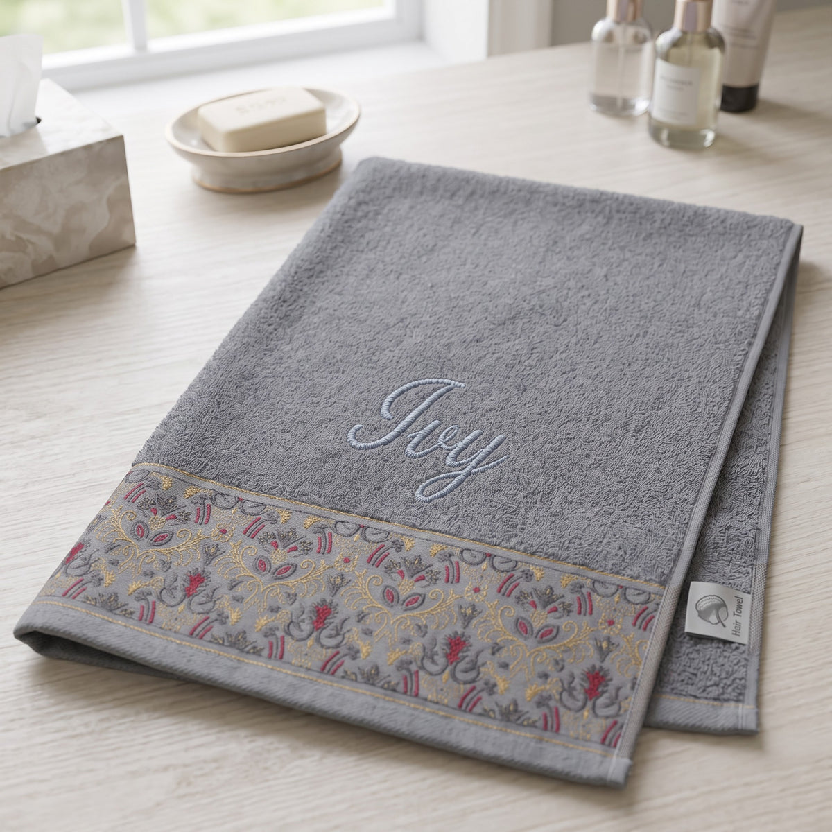 Ivy personalized hair towel, light blue script embroidery on light gray cotton with a patterned border — photo 4