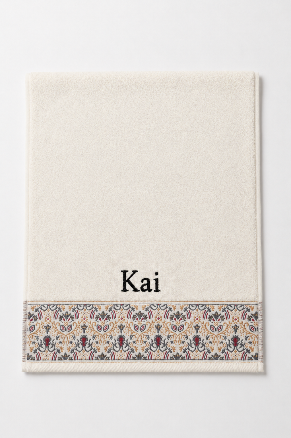 Kai personalized hair towel, black serif embroidery on ivory cotton with a patterned border