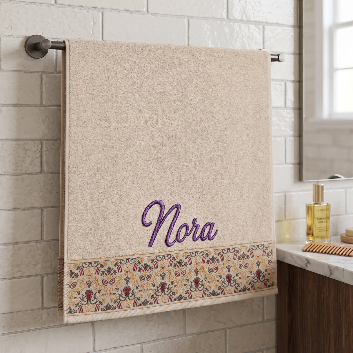 Nora personalized hair towel, purple script embroidery on cream cotton with a patterned border