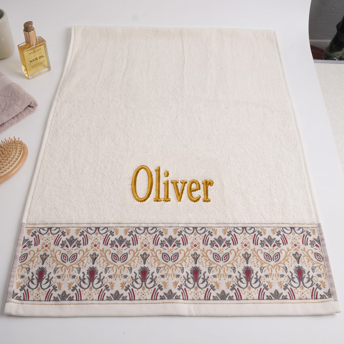 Oliver personalized hair towel, gold serif embroidery on ivory cotton with a patterned border — photo 3