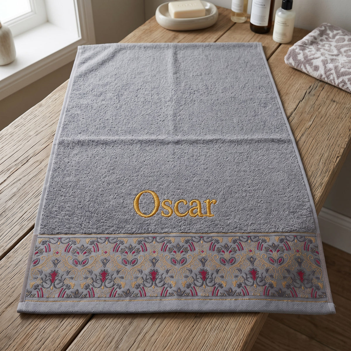 Oscar personalized hair towel, gold serif embroidery on light gray cotton with a patterned border — photo 4