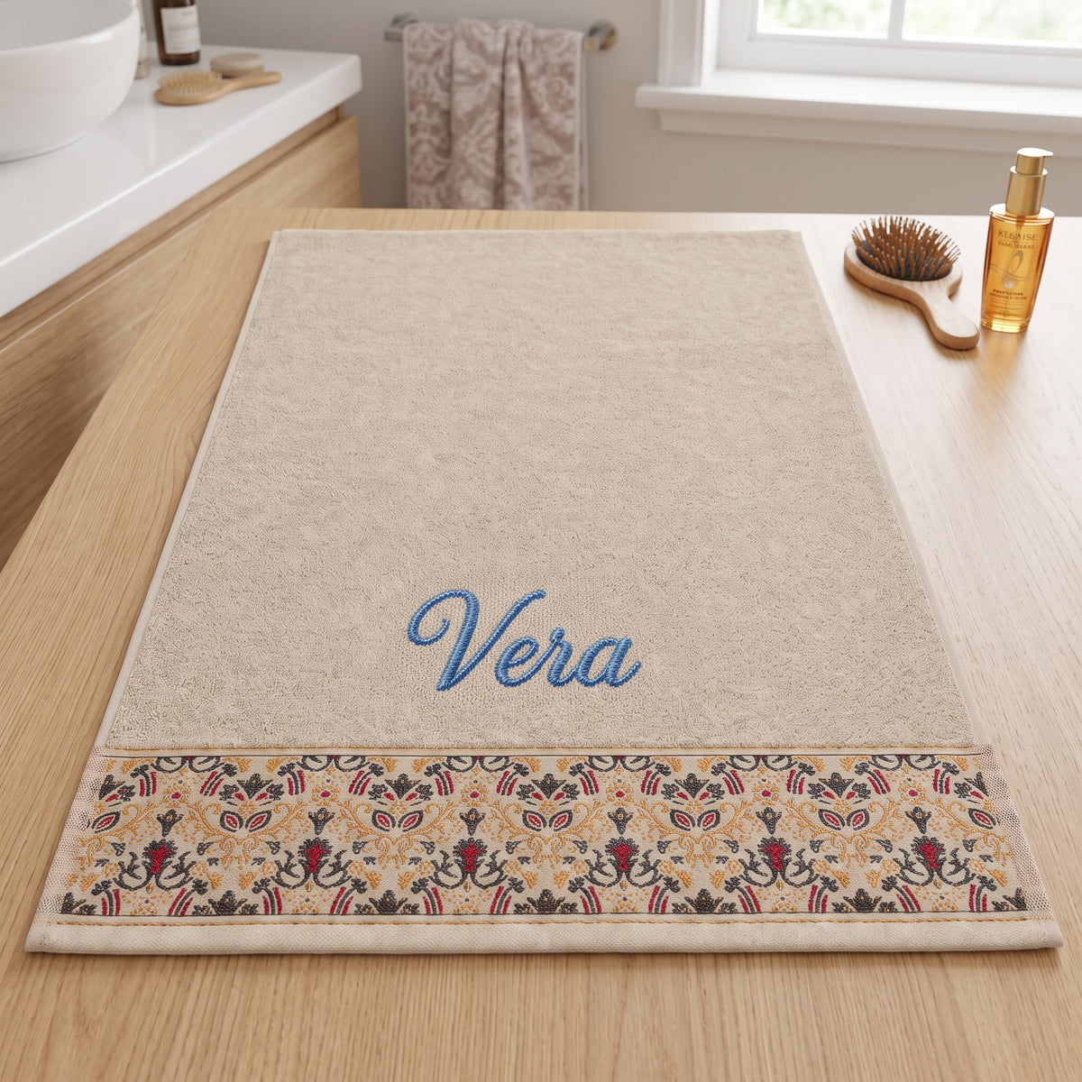 Vera personalized hair towel, blue script embroidery on cream cotton with a patterned border