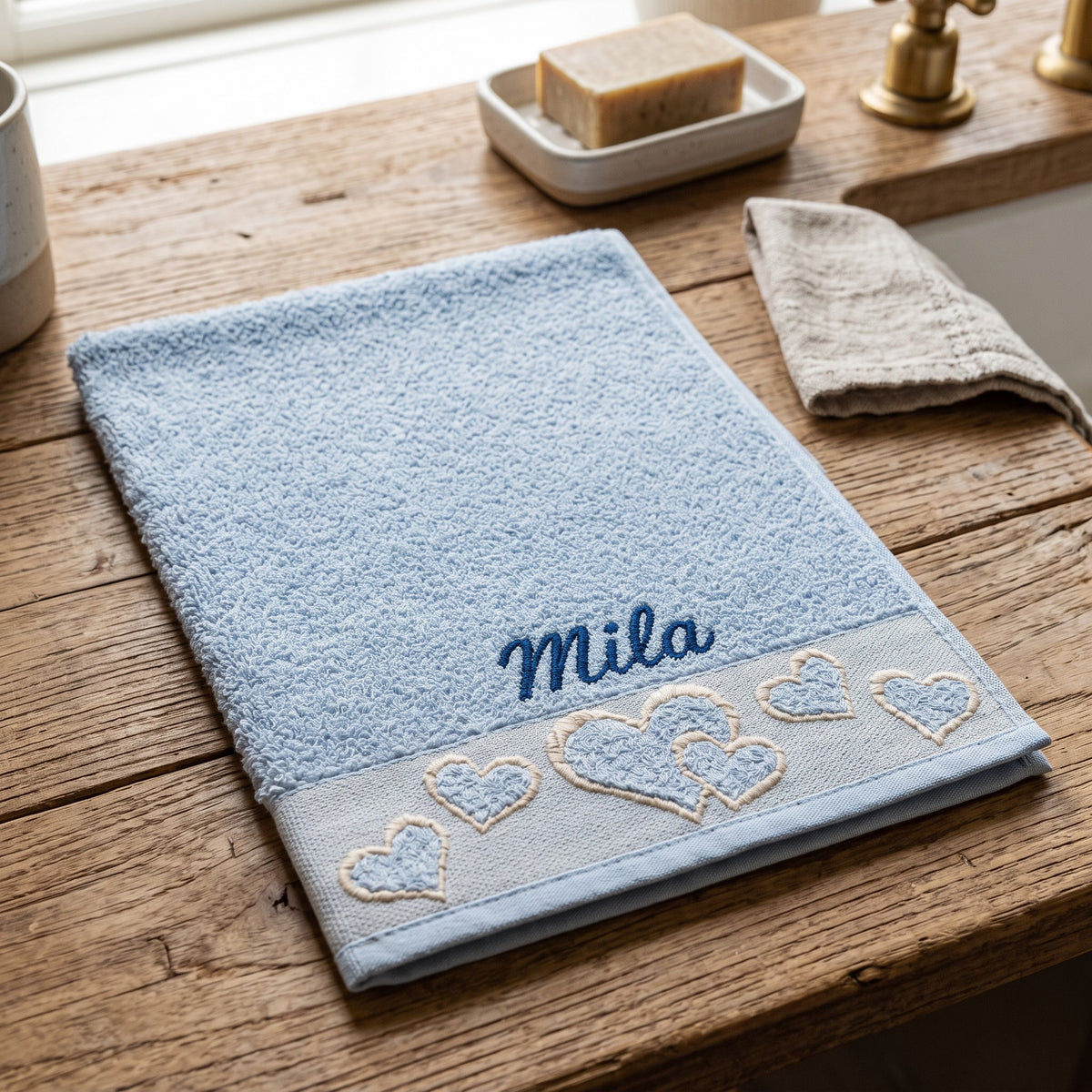 Mila personalized heart hand towel, navy script embroidery on baby blue cotton — photo 4