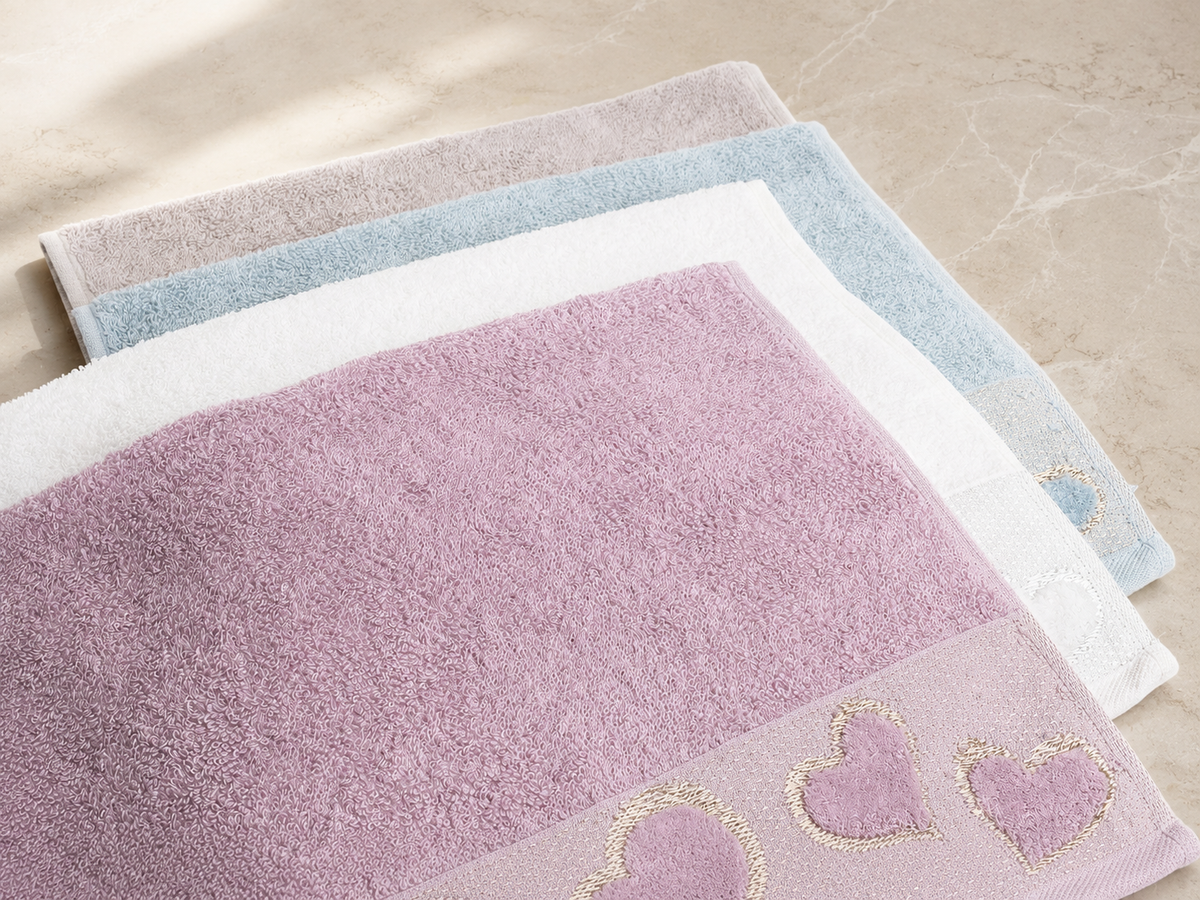Plain cotton heart hand towels in baby blue, white, lilac and mauve