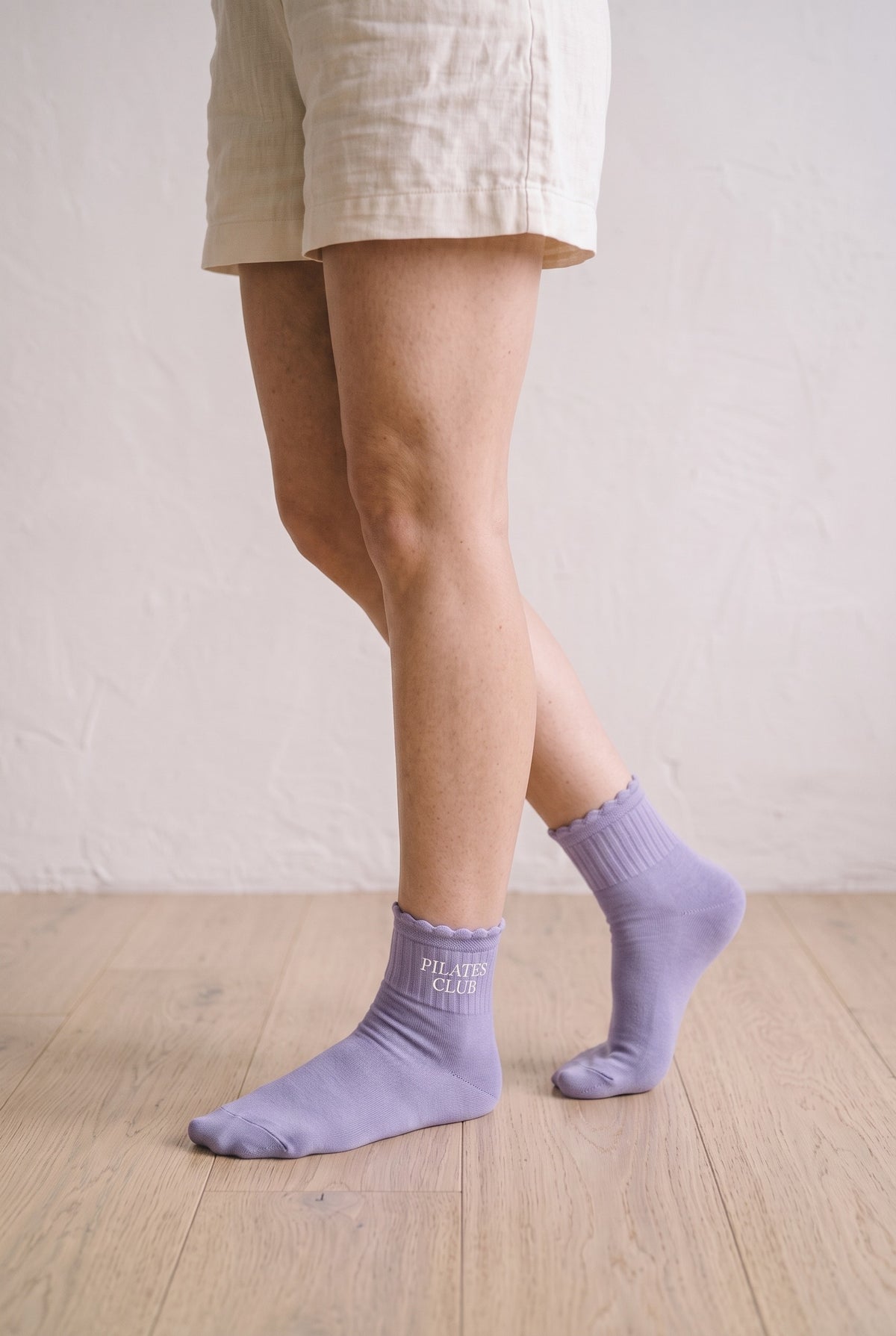 Model wearing lilac embroidered ruffle ankle socks, second view