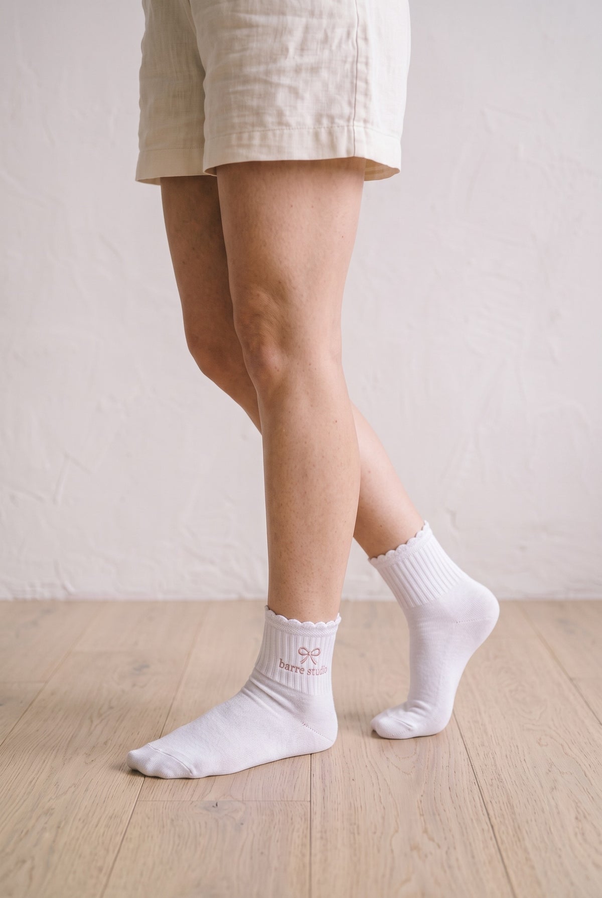 Model wearing white melange embroidered ruffle ankle socks, second view
