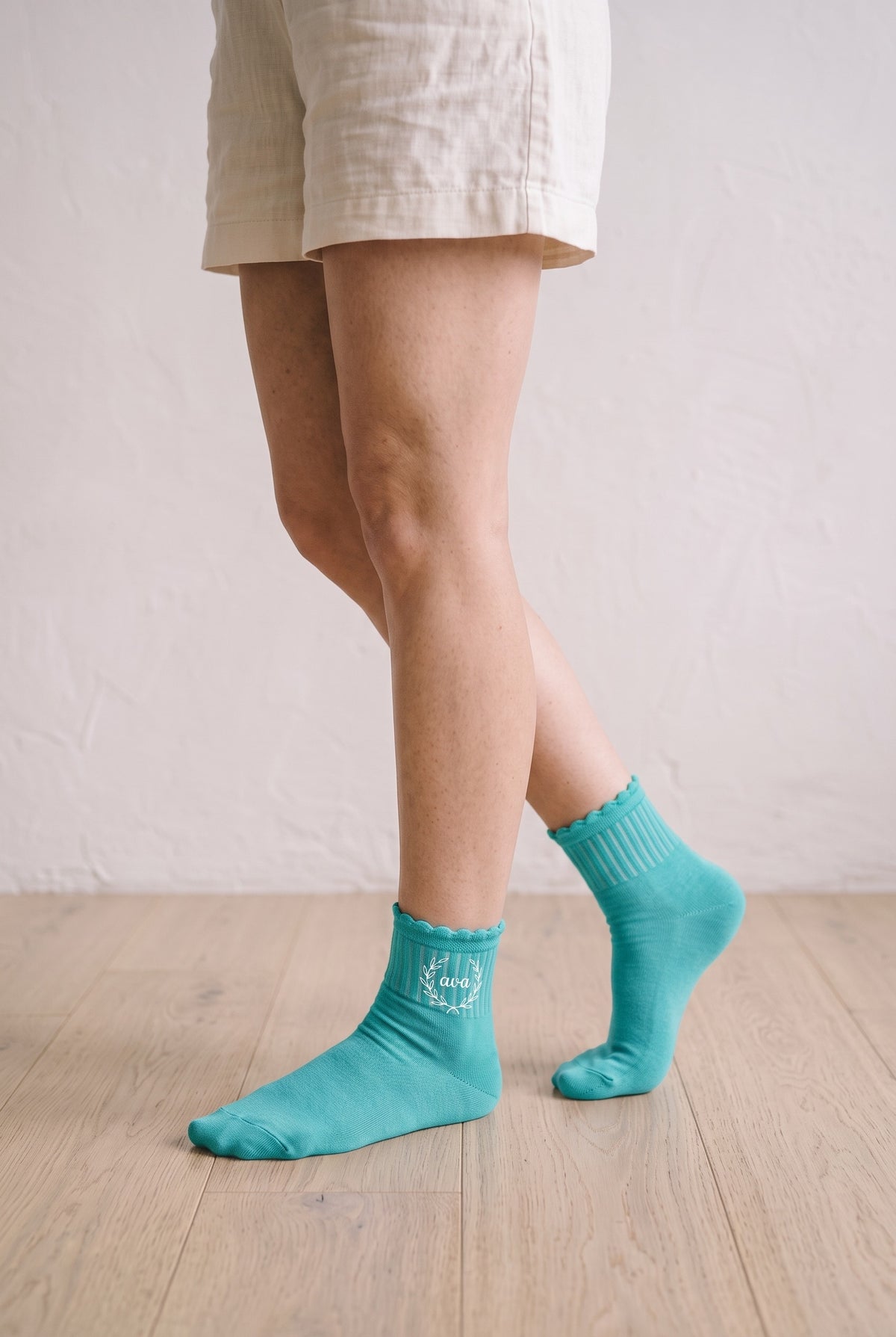Model wearing mint embroidered ruffle ankle socks, second view