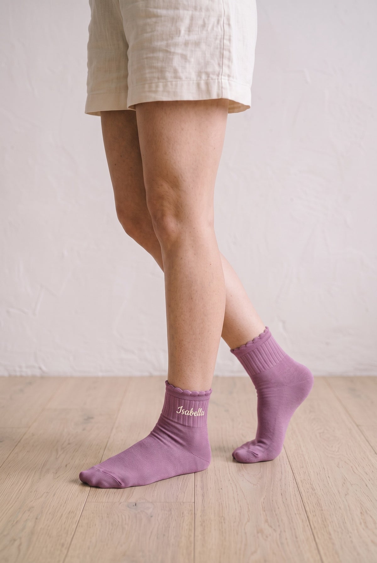 Model wearing dusty rose embroidered ruffle ankle socks, second view