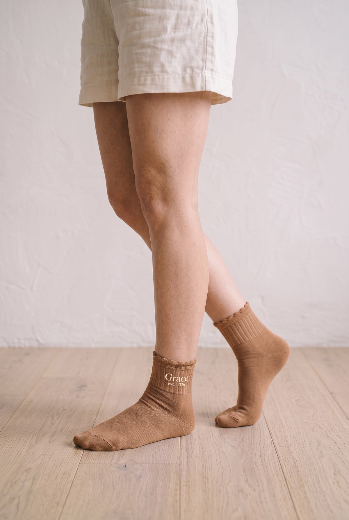 Model wearing camel embroidered ruffle ankle socks, second view