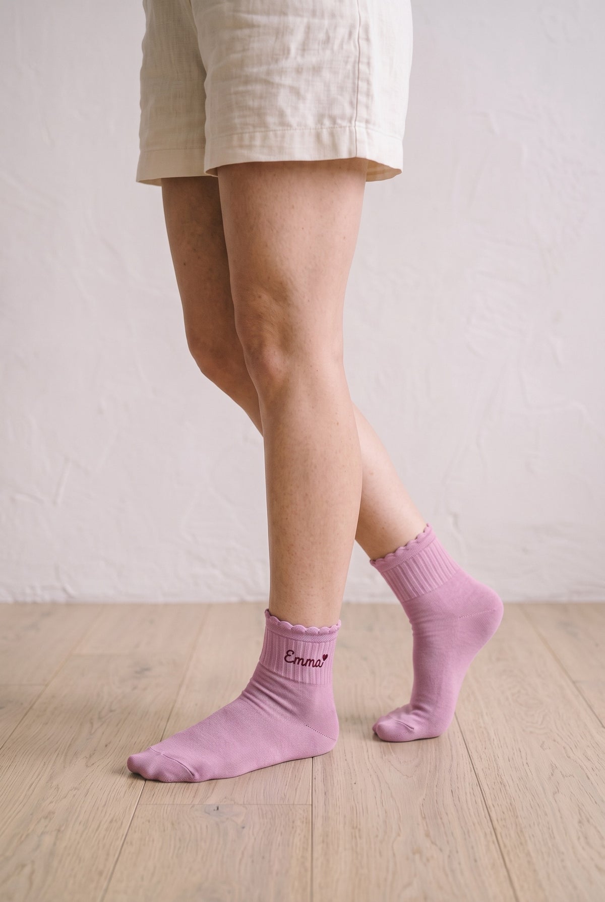 Model wearing pink embroidered ruffle ankle socks, second view