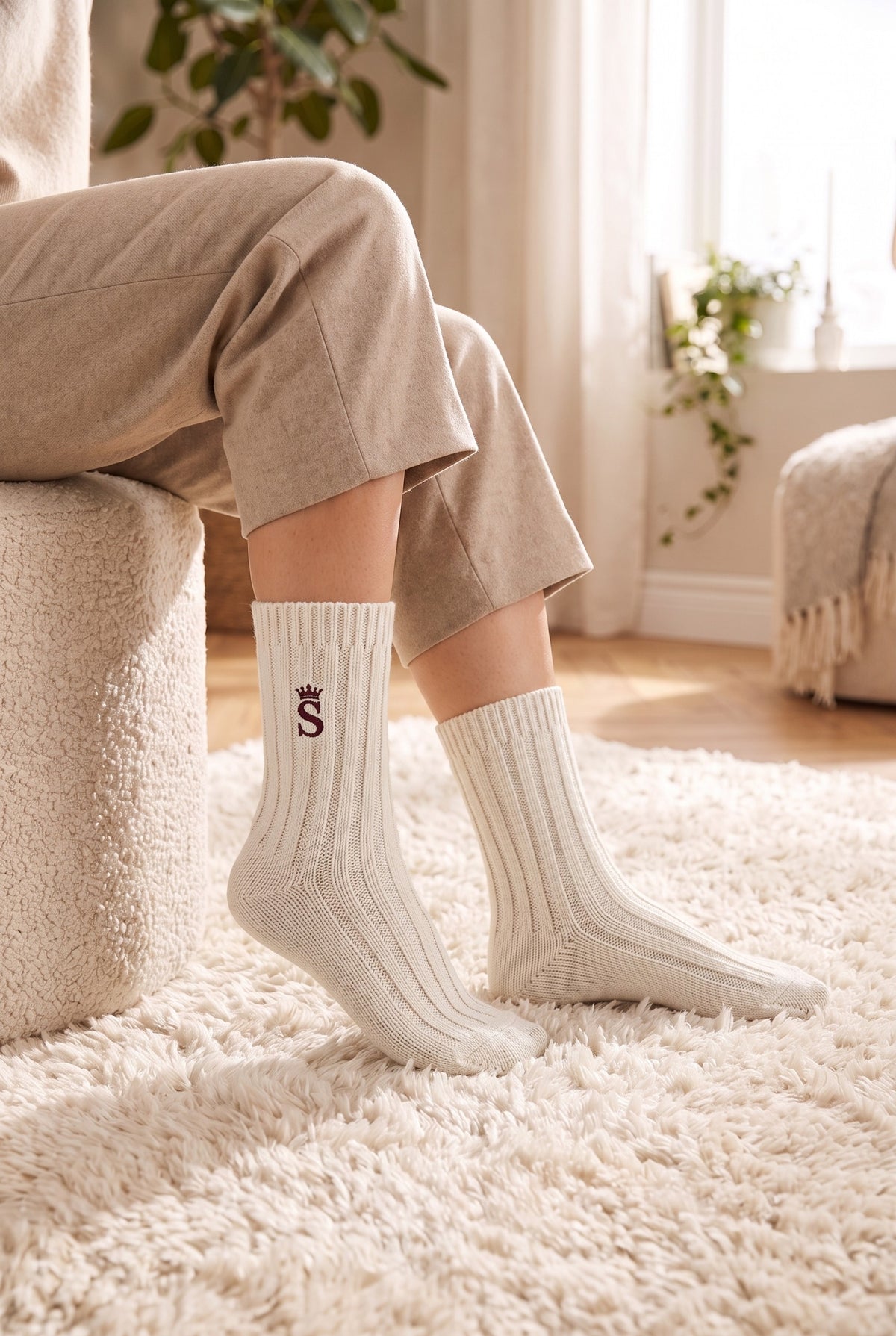 Model wearing off white embroidered women's wool socks