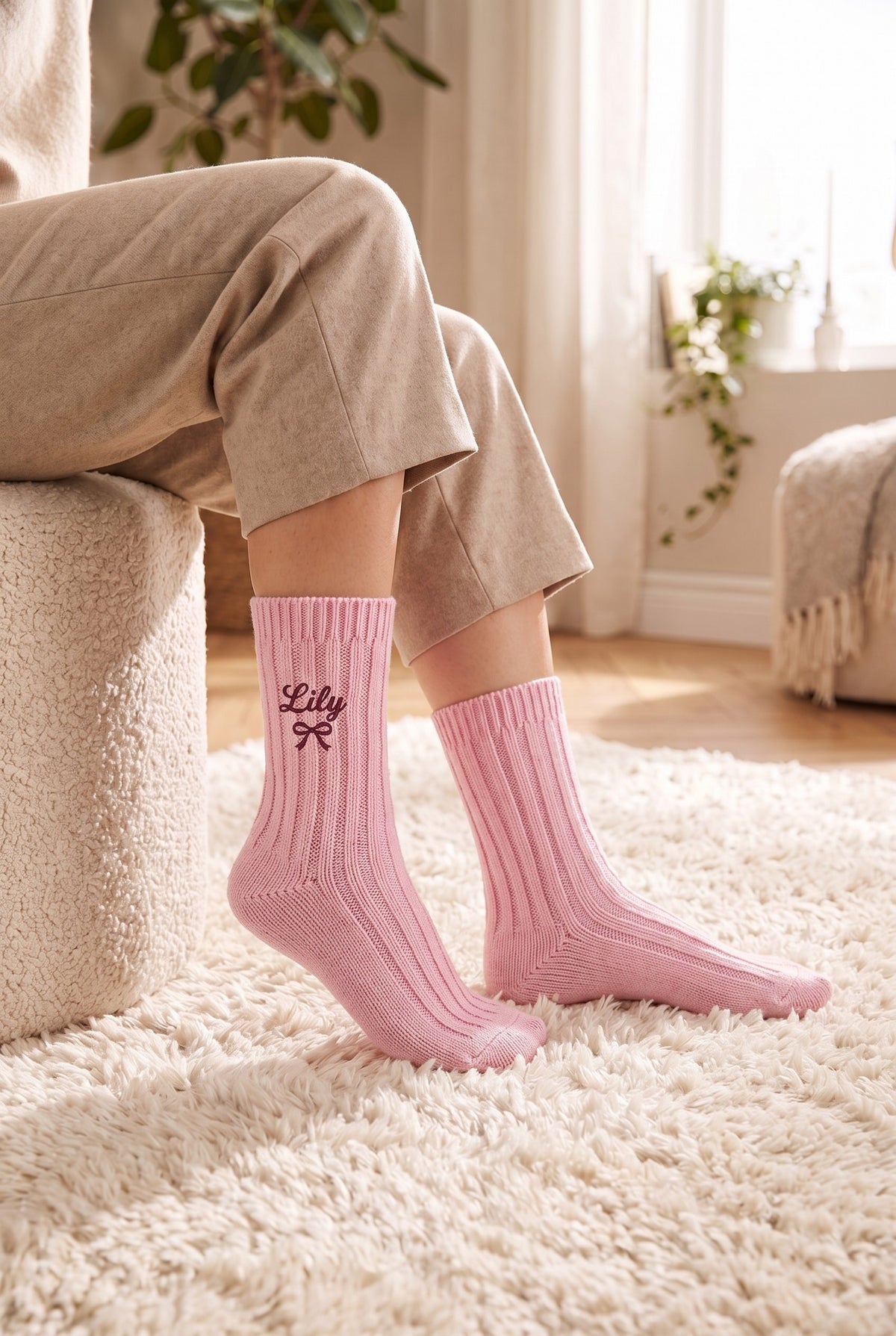 Model wearing powder pink embroidered women's wool socks