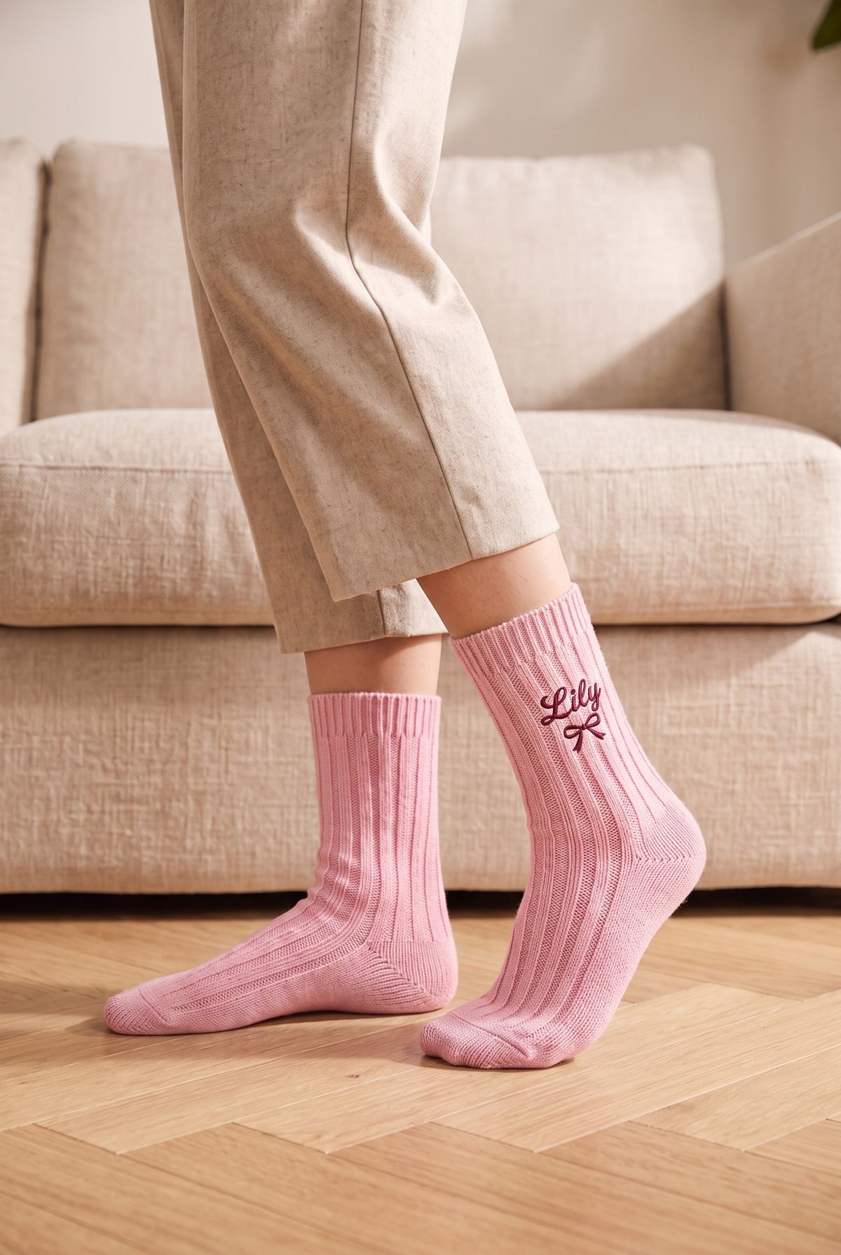 Model wearing powder pink embroidered women's wool socks, second view