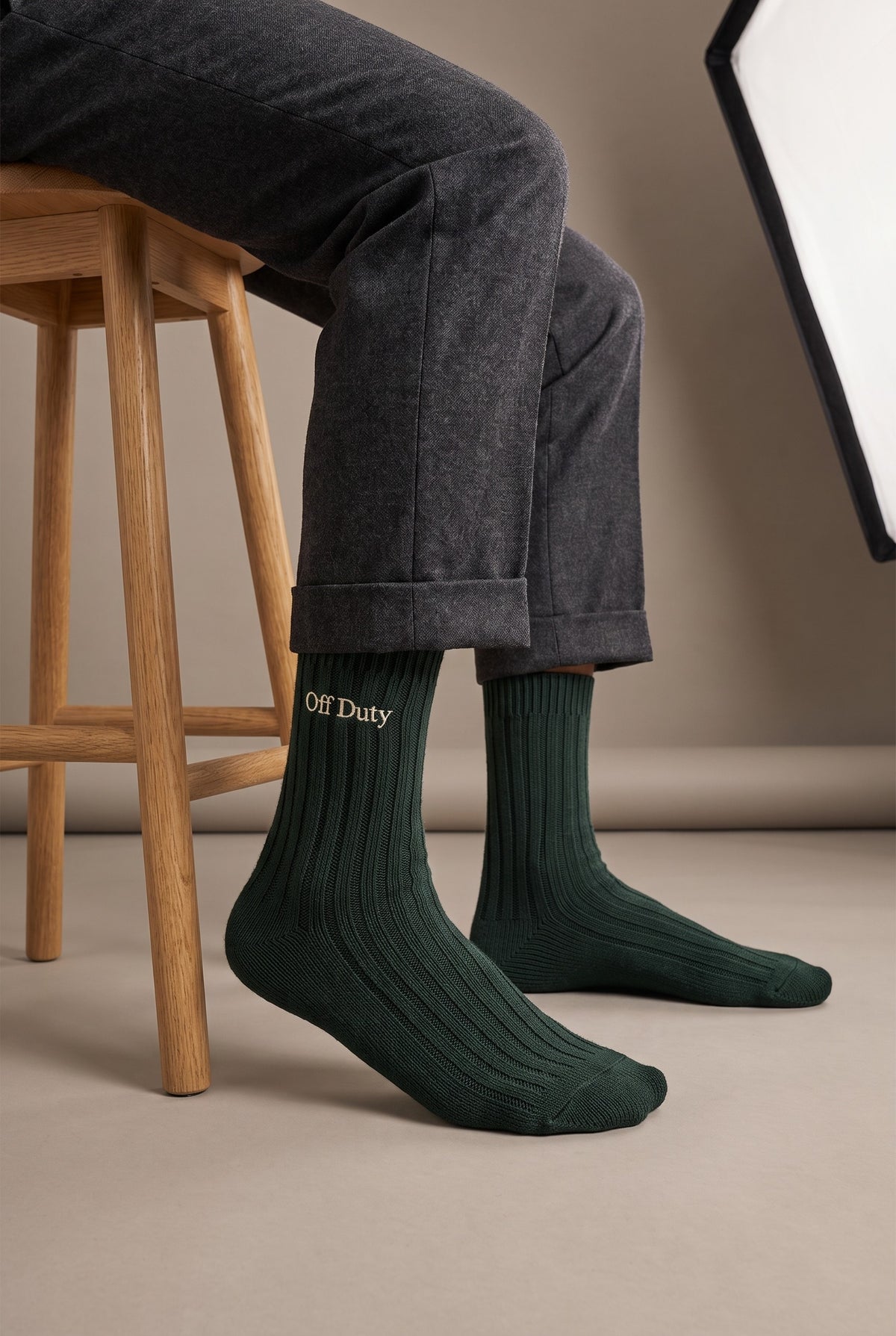 Model wearing green embroidered men's wool socks