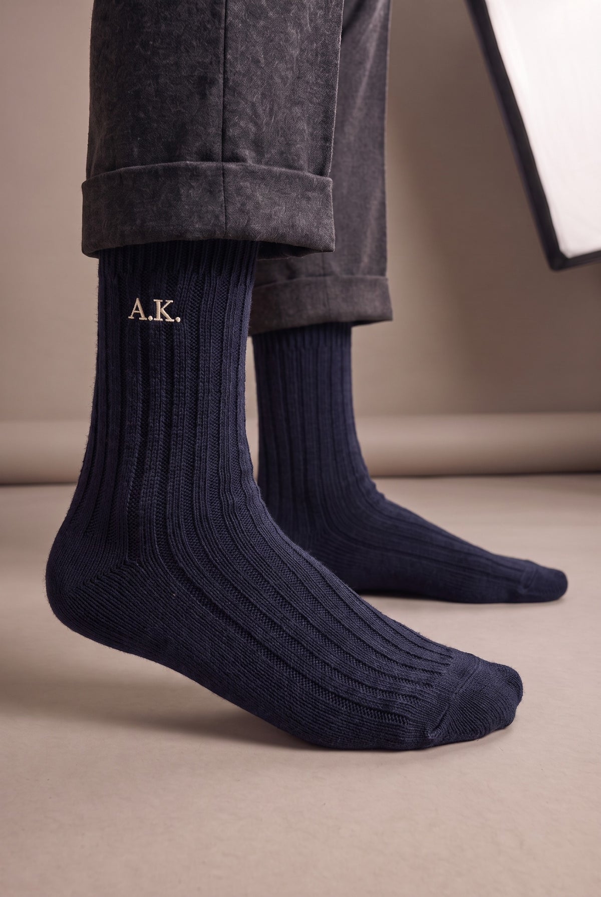 Model wearing navy embroidered men's wool socks, second view