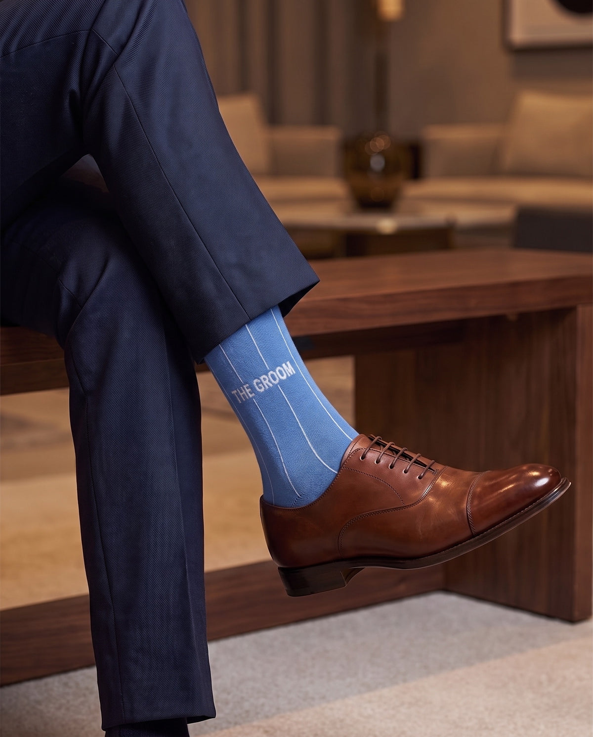 Model wearing blue embroidered groom dress socks