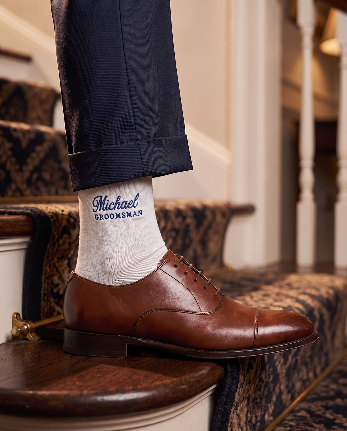 Model wearing white embroidered groom dress socks, second view