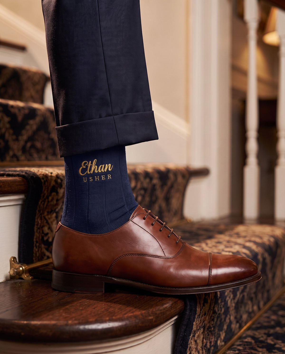 Model wearing navy embroidered groom dress socks, second view