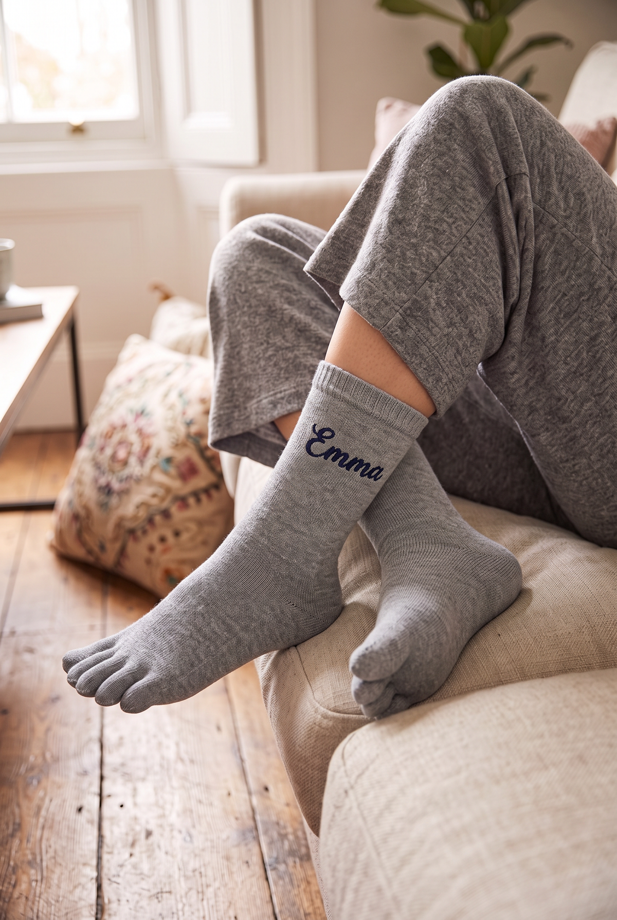 Model wearing grey embroidered toe socks