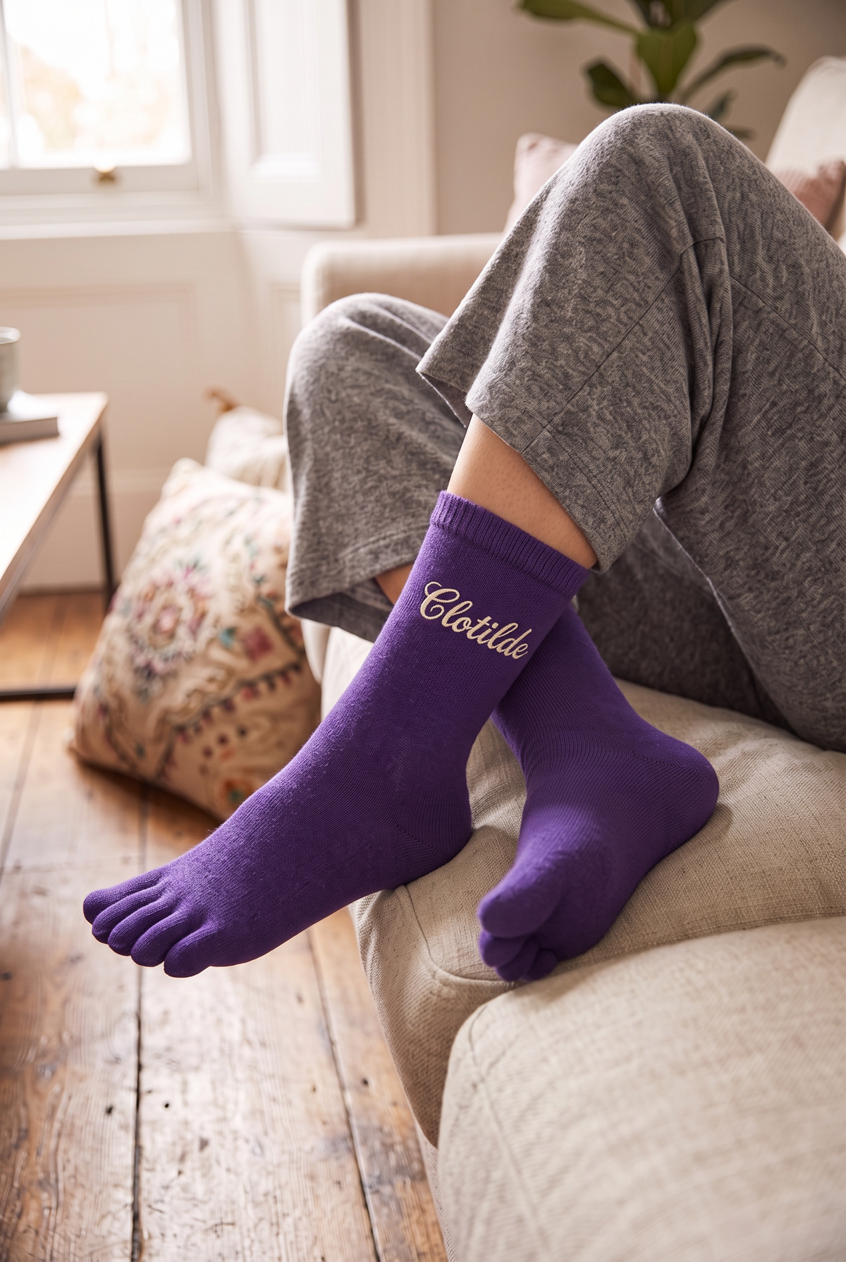 Model wearing purple embroidered toe socks