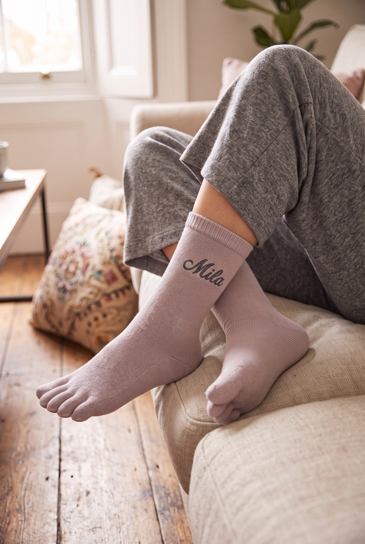 Model wearing powder pink embroidered toe socks