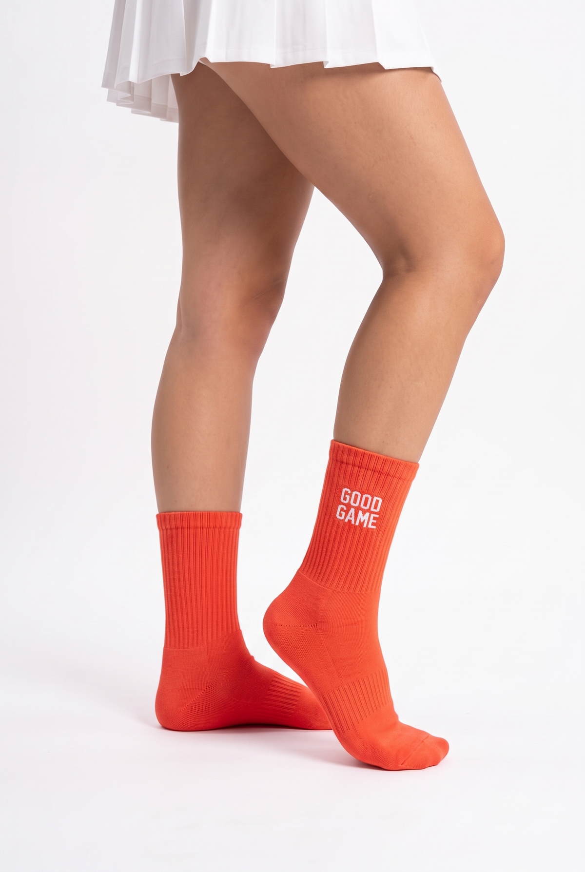Model wearing orange embroidered tennis socks