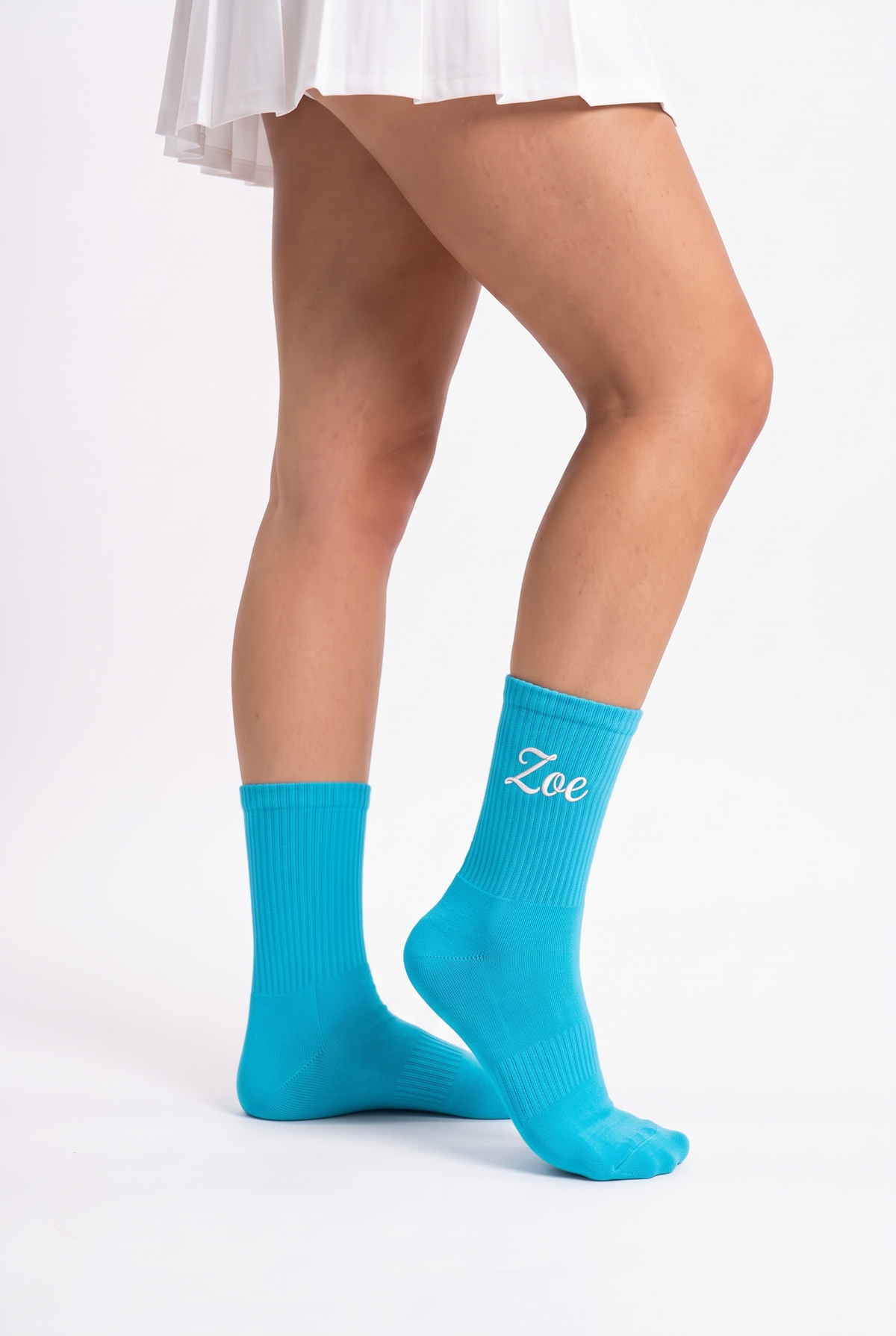 Model wearing turquoise embroidered tennis socks