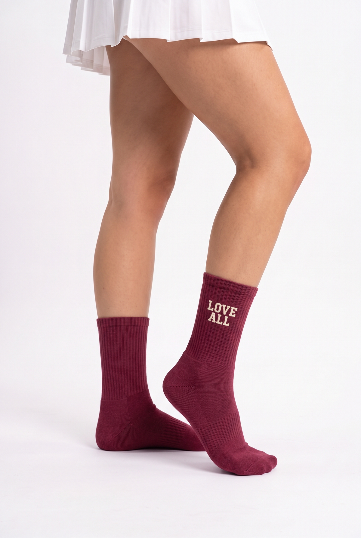 Model wearing burgundy embroidered tennis socks
