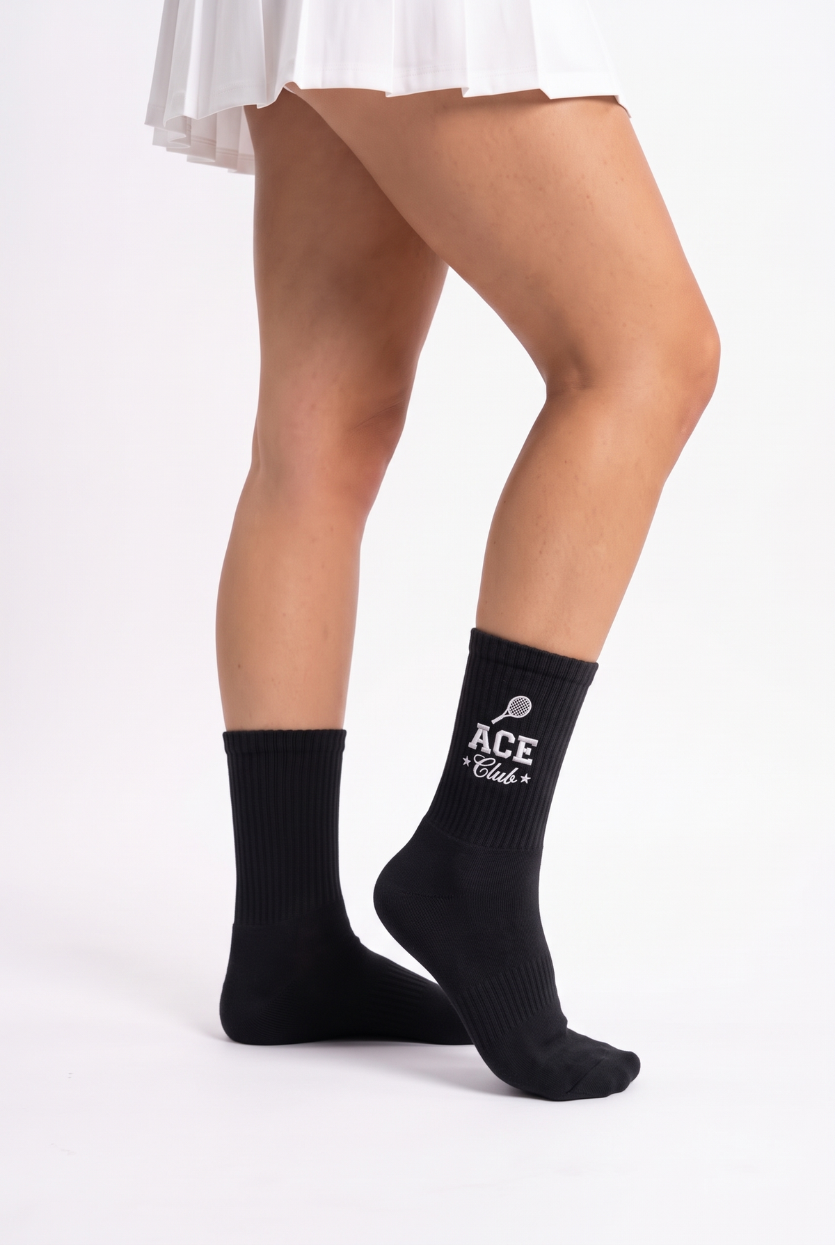 Model wearing black embroidered tennis socks