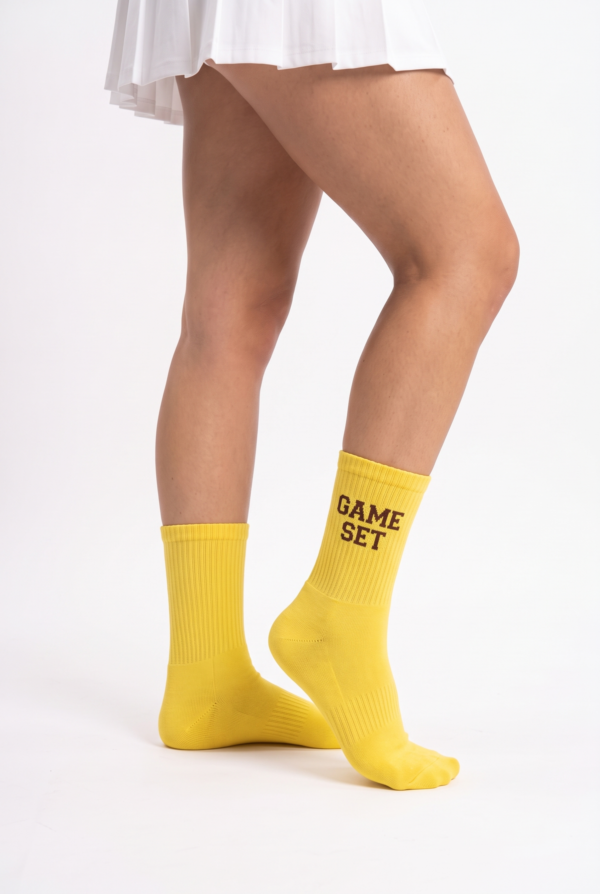 Model wearing yellow embroidered tennis socks