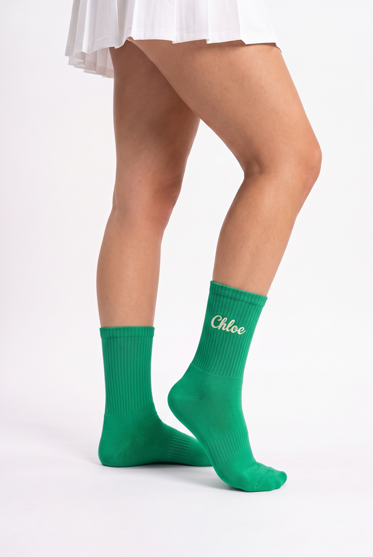 Model wearing green embroidered tennis socks