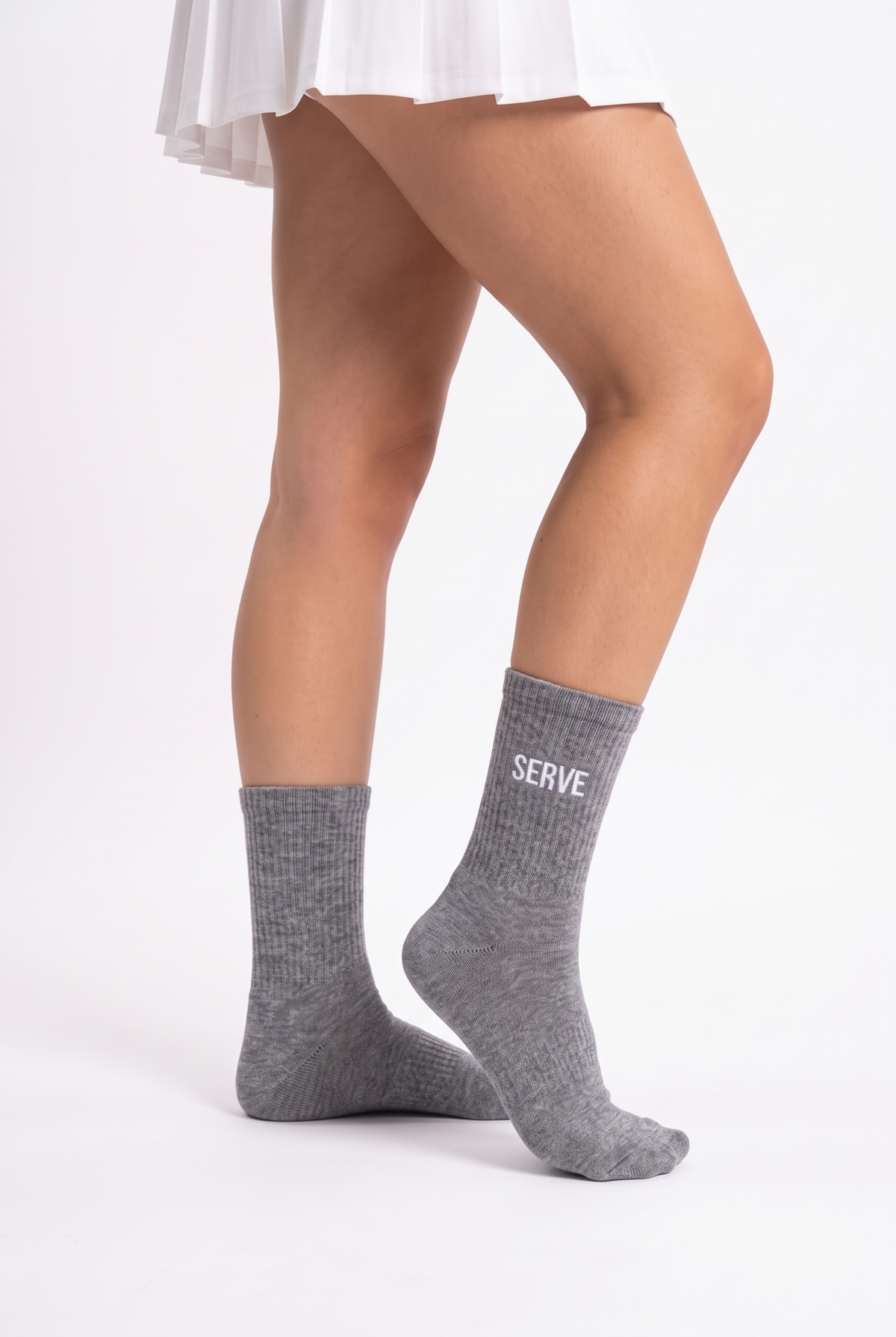 Model wearing grey embroidered tennis socks