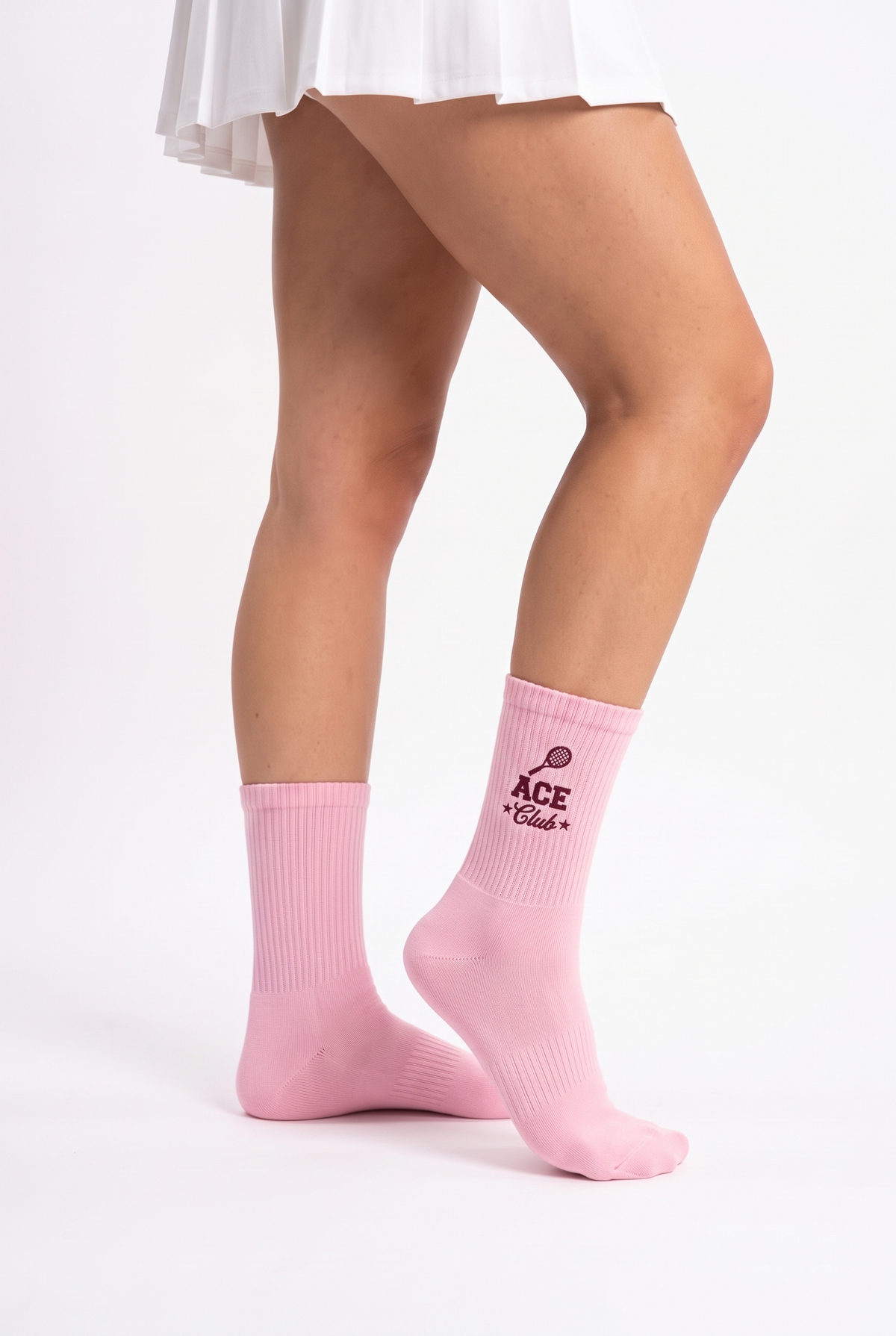 Model wearing pink embroidered tennis socks