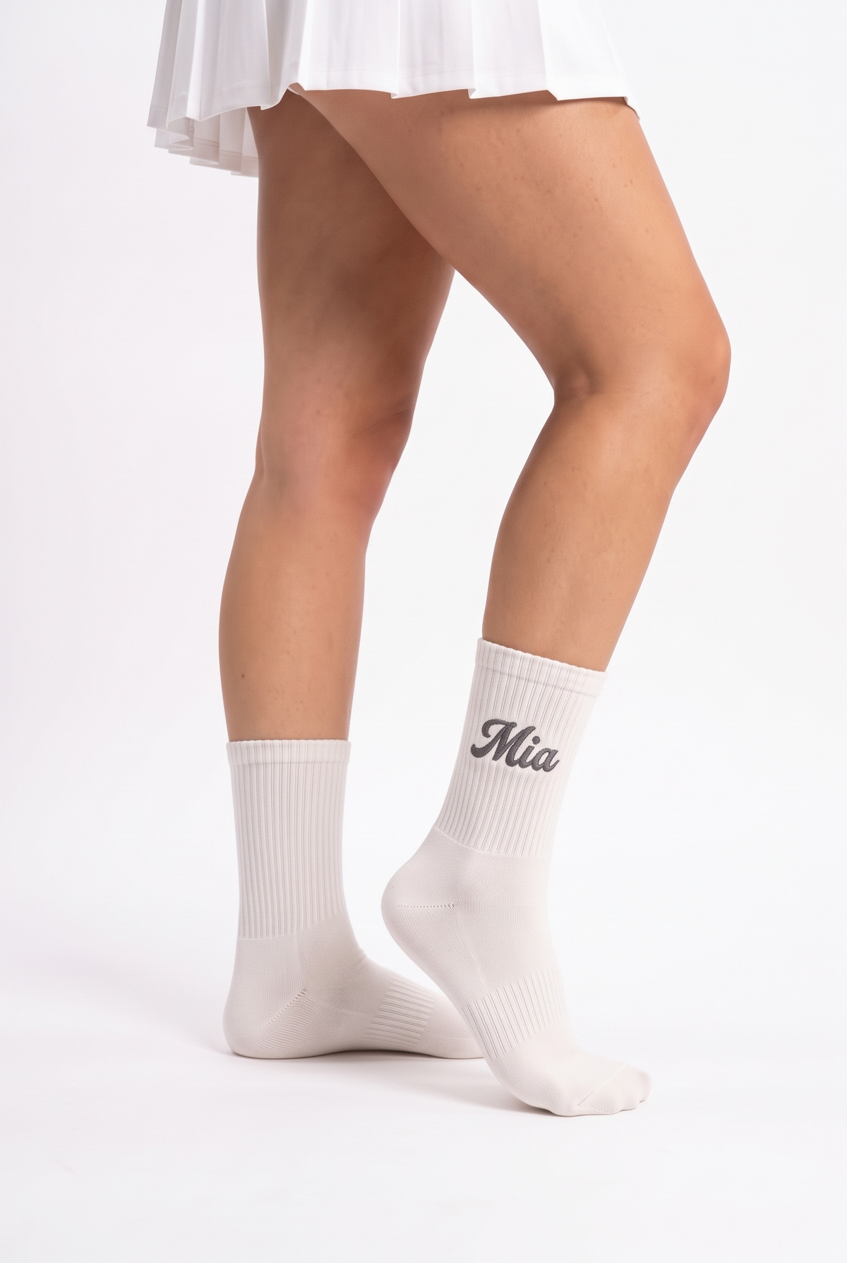 Model wearing off white embroidered tennis socks