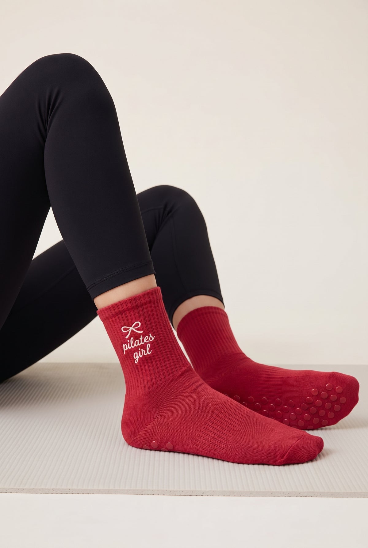 Model wearing red embroidered dot grip pilates socks