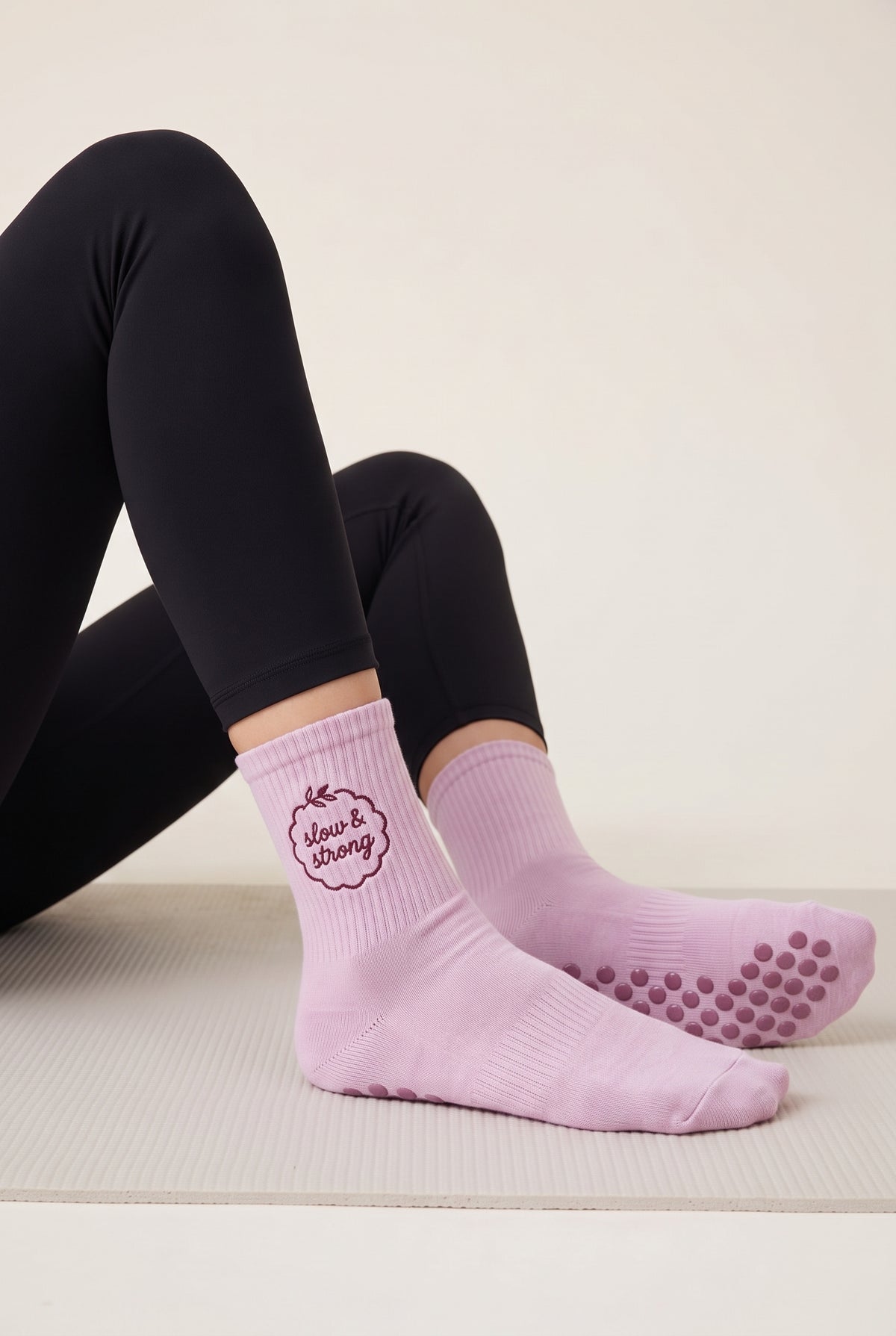 Model wearing pink embroidered dot grip pilates socks