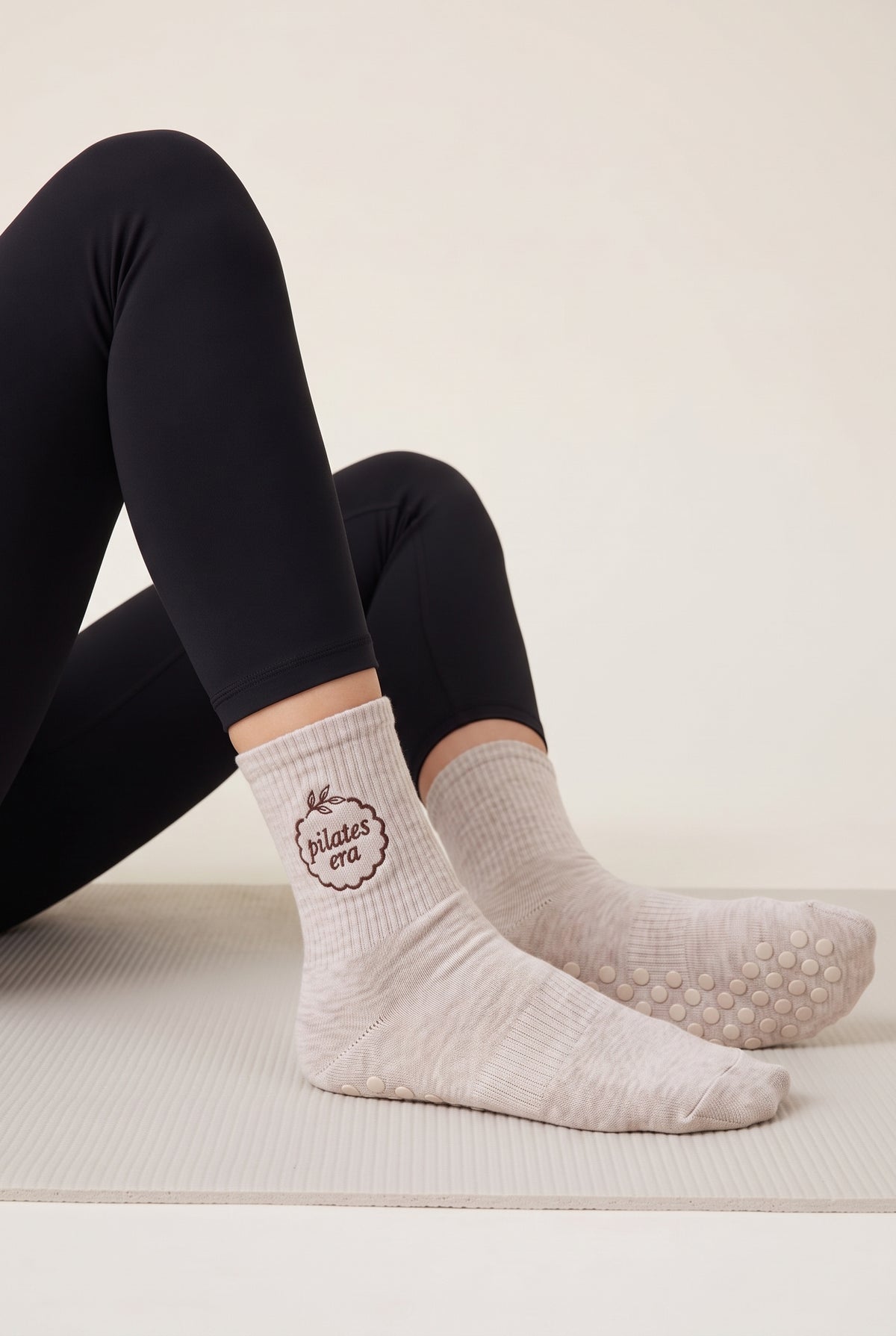 Model wearing beige melange embroidered dot grip pilates socks