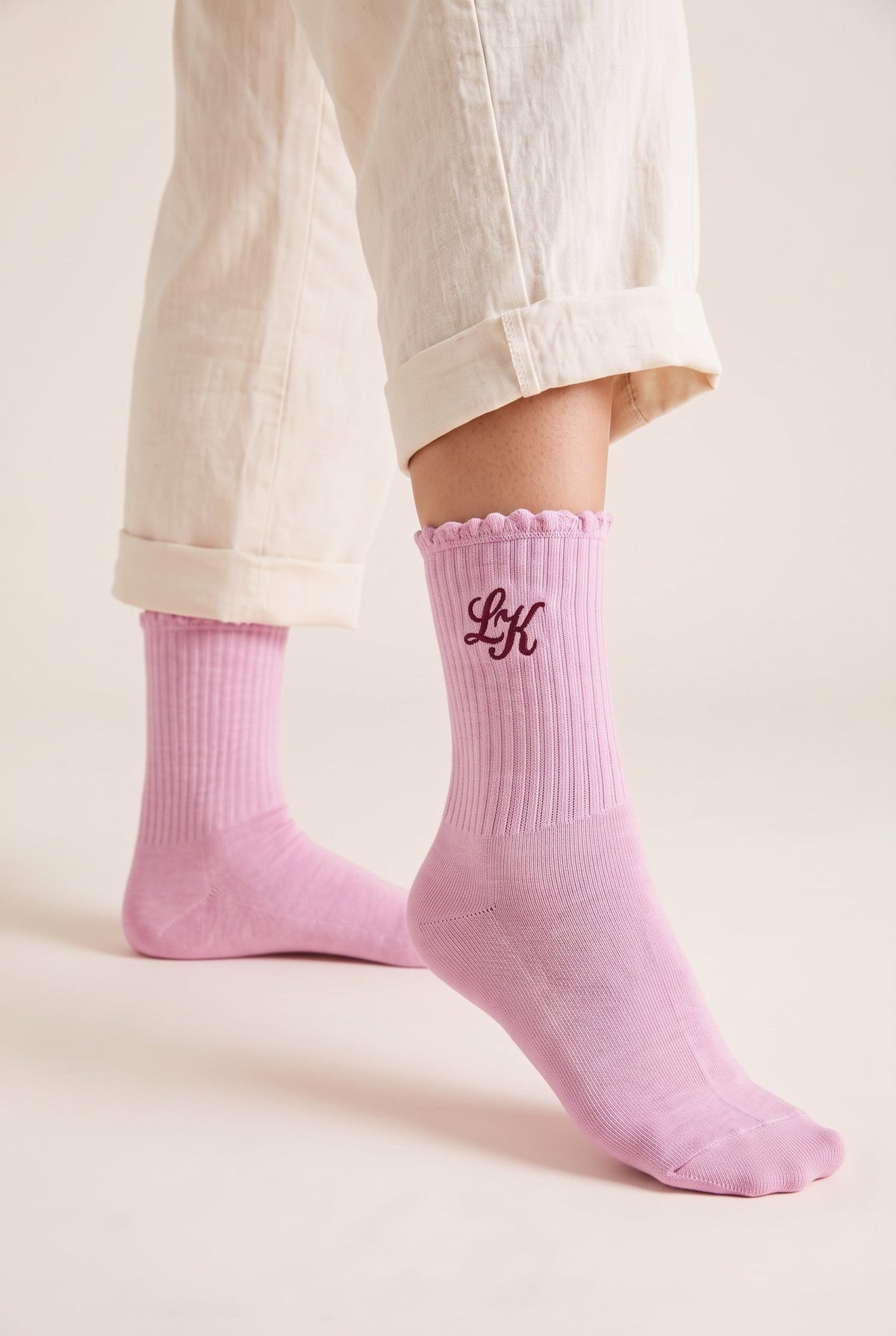 Pink personalized embroidered ruffle socks, worn, second angle — made to order
