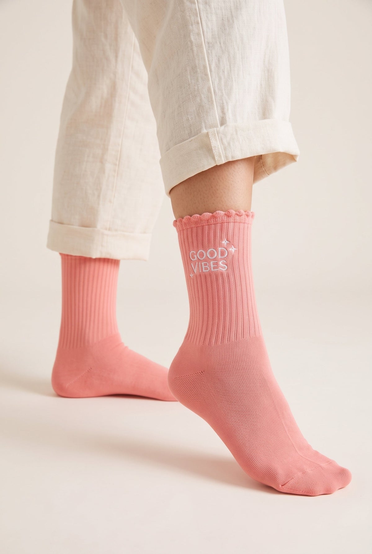 Salmon personalized embroidered ruffle socks, worn, second angle — made to order