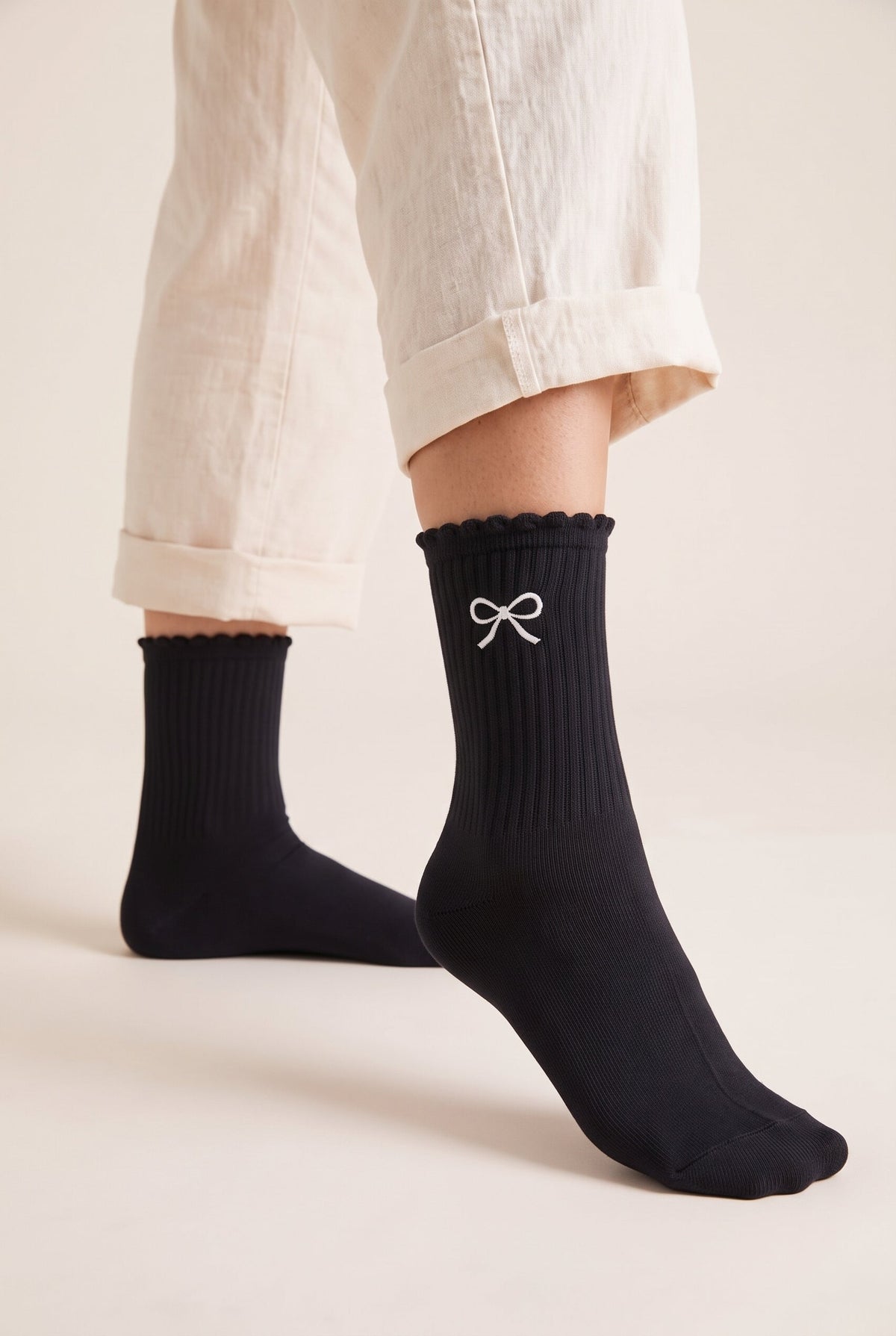 Black personalized embroidered ruffle socks, worn, second angle — made to order