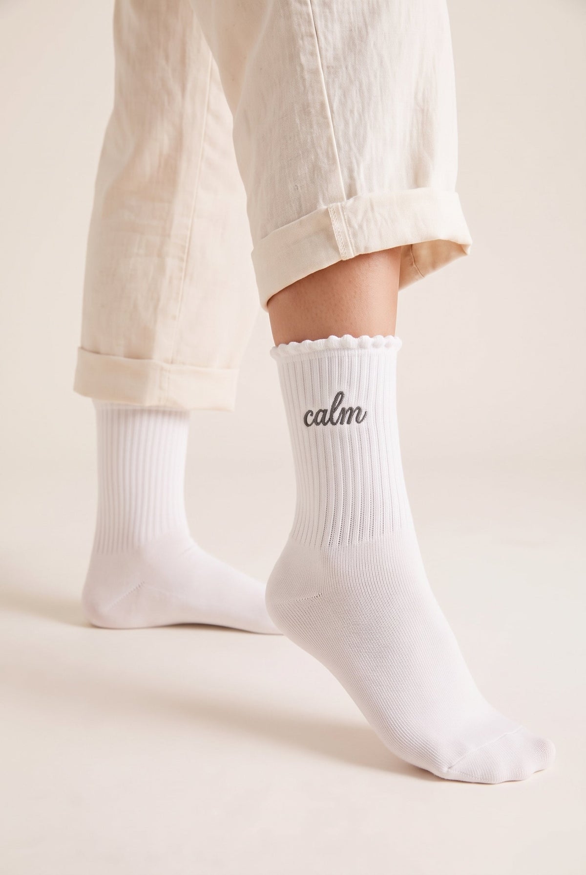 Cream personalized embroidered ruffle socks, worn, second angle — made to order