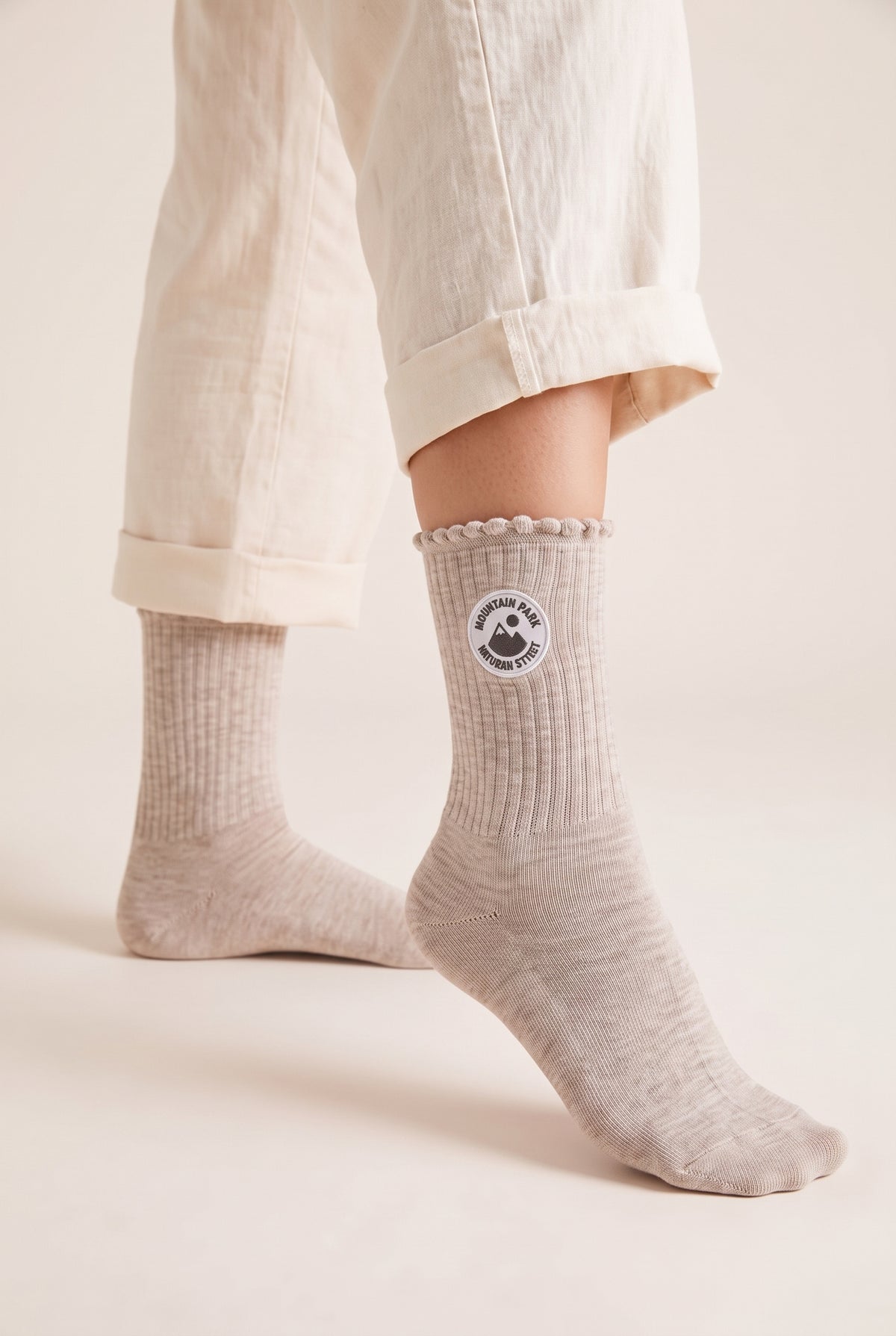 Beige personalized embroidered ruffle socks, worn, second angle — made to order