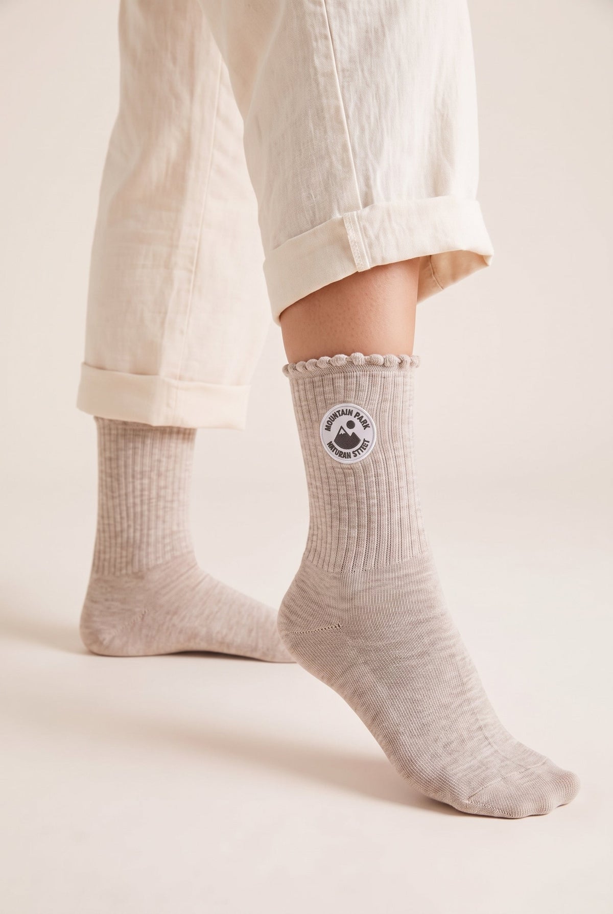 Beige personalized embroidered ruffle socks, worn, second angle — made to order