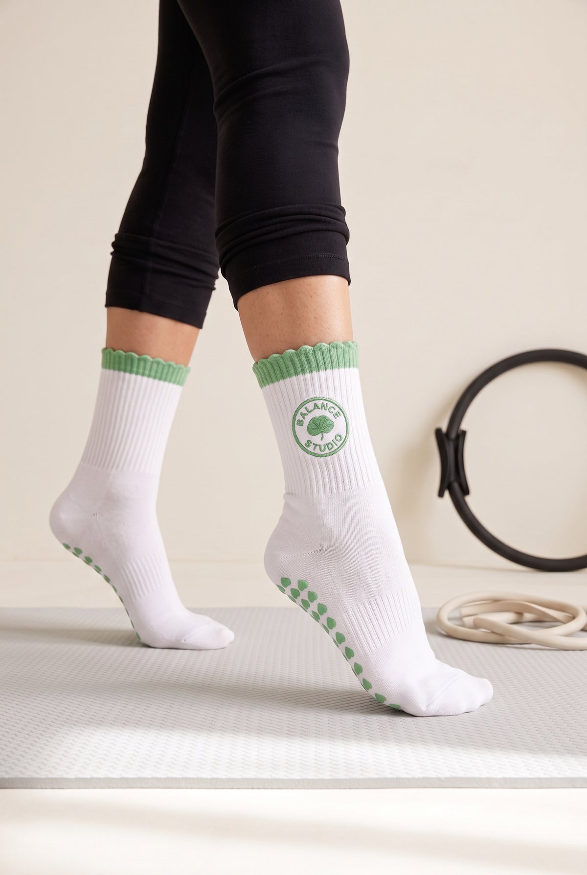 Green ruffle pilates grip socks, worn in a pilates studio — embroidered to order