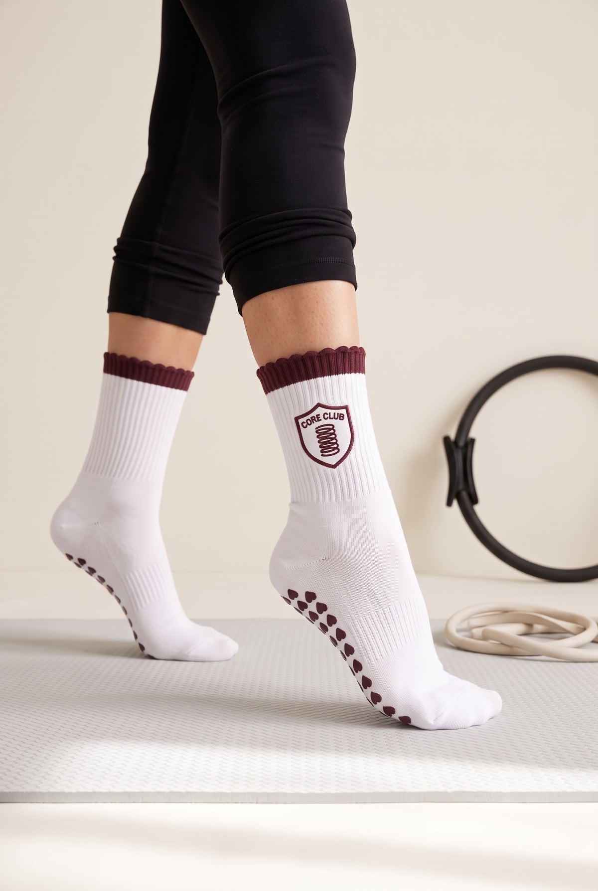 Burgundy ruffle pilates grip socks, worn in a pilates studio — embroidered to order